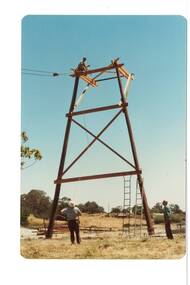 Poppet head being raised. Erection work in progress. Workmen.

