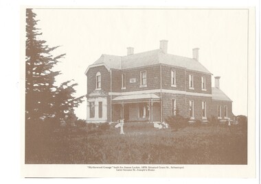 Substantial two story brick mansion, bay window and verandah front, mansard roof.