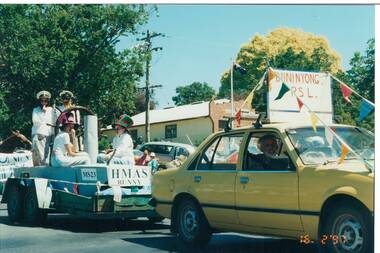 View of the Buninyong RSL car (Derek Leather driving) with trailer featuring HMAS Bunny complete with ship's wheel and naval personnel aboard.