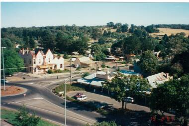 Aerial view of intersection, showing roundabout, Hotel, shops, park