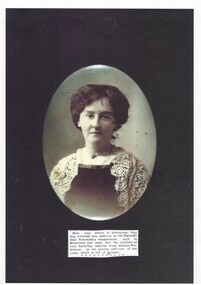 Oval head and shoulders portrait of young lady in dark dress with lace shawl, hair up.