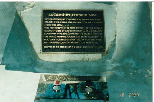 Close up of the Locomotive Extended Mine Plaque and the medals awarded to John Silvey and William Sandford for their rescue attempt