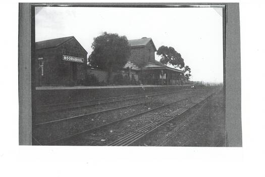 View of the platform and Station buildings of Moorabool Station with two rail lines in the foreground circa 1922