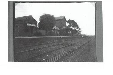 View of the platform and Station buildings of Moorabool Station with two rail lines in the foreground circa 1922