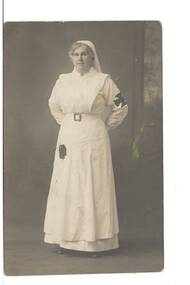 A postcard from the studio of A. Verey & Co, of Castlemaine, showing a full-length portrait of an Army Nurse in uniform. 