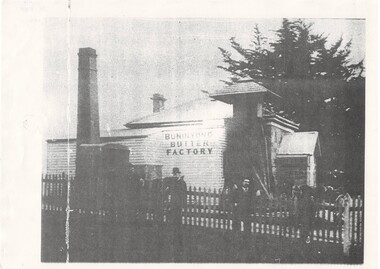 The weatherboard facade prominently displays the name of Buninyong Butter Factory and an unusual canopied chimney can be seen to the right.