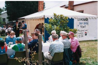 Colour photograph of Lemonade (Sly Grog) tent and customers seated at tables in The Old Library gardens in Warrenheip Street 1998