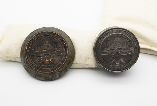 Metal seal and imprint embedded in wood