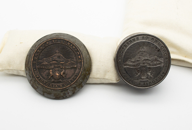 Metal seal and imprint embedded in wood