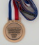 Medal with red, white and blue ribbon commemorating centenary of Buninyong W.W.I Avenue of Honour