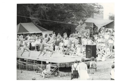 Black and White image of an athletic performance on stage in De Soza Park for the Buninyong Festival 1984