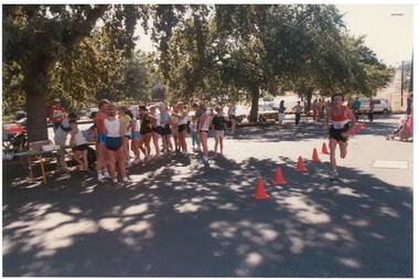 Colour photograph of fun run in progress, Learmonth Street showing officials, participants and spectators