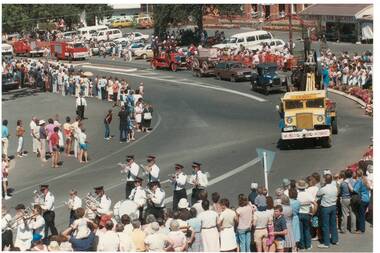 Colour photograph showing part of Festival procession 1985 featuring a brass band and various historical and contemporary motor vehicles