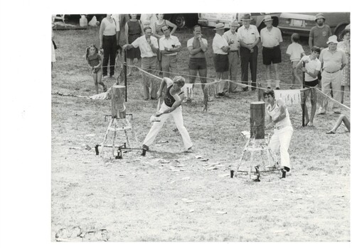 Black and white photograph of Buninyong Festival woodchop1984, spectators to the rear showing local identity Charlie Coxall at right in group of four 