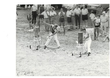 Black and white photograph of Buninyong Festival woodchop1984, spectators to the rear showing local identity Charlie Coxall at right in group of four 