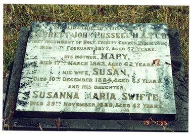 Headstone of Garrett John Russell and members of his family, marble, inlaid brass letters, some missing.