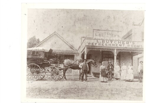 Black and white image of a horse drawn cab and several residents outside Butcher's Refreshment Rooms circa 1890s