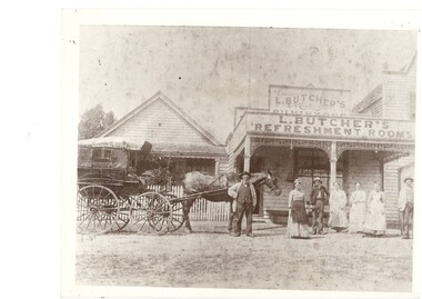 Black and white image of a horse drawn cab and several residents outside Butcher's Refreshment Rooms circa 1890s