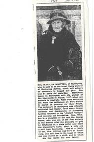 Newspaper article with monochrome photo of elderly lady wearing felt brimmed hat with dark band, black coat with fur collar, gloves and handbag.