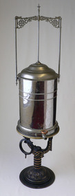 A nitrous oxide gasometer on a plain neutral grey background.