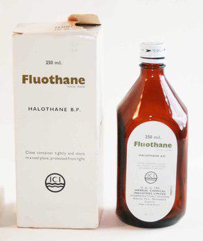 An empty brown glass bottle stands next to a white carboard box. Both have distinct green labelling.