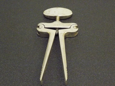 Scissor-like metal device with a screw mechanism at the top which allows for the open or closed position to be locked.