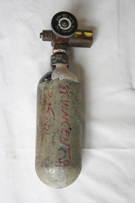 Empty small pale green painted cylinder with rounded base and attached outflow valve with circular 'On-Off' knob.
