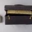 A black doctor's bag with brass clips, where manuscripts have been used as the lining for the bag.