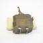 A scarificator made of brass, in a squarish shape, with a lever at the top. At the base of the object is a series of ten slits, through which metal blades emerge once the lever is pushed. 