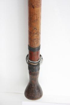 The mouthpiece for the blowpipe has been carved out of one section and attached to the tube. The engravings represent plants used to develop the poison used in hunting.