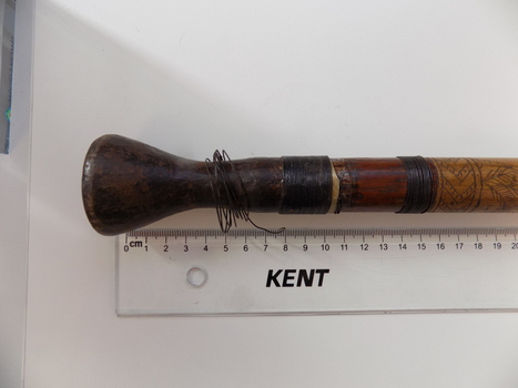 The mouthpiece has been attached to the blowpipe using tree gum or beeswax and strands of rattan have been wrapped around the join to further secure it.