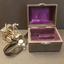 Housed in a purple-lined, leather case with a metal hinge and clasp, the sphygmograph had a black fabric strap which is used to attach to the patient’s wrist.