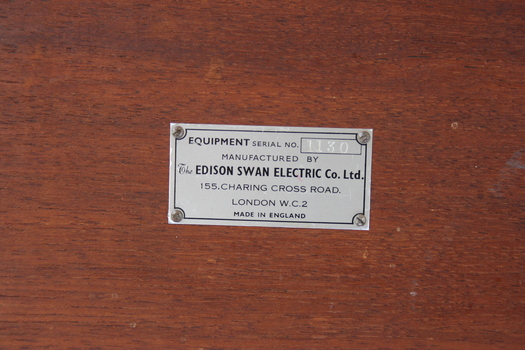 A small. rectangular, metal manufacturer's plaque is affixed to the rear of the box. The plaque reveals the machine to have been made by The Edison Swan Company of Charing Cross Road, London.