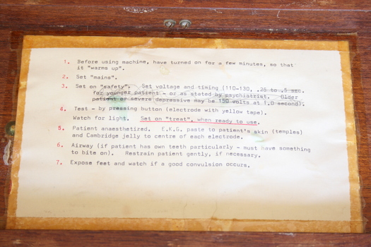 Affixed to the inside lid of the wooden box is a typed instruction sheet with seven steps for the practitioner to follow.