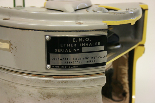 A label on the side of the inhaler detailing manufacturing information. Part of it has been cut off by sectioning.