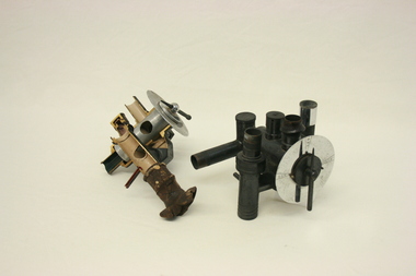 Two Renton circle valve absorbers. The one on the left has been sectioned.