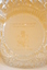 The etching on the back of the crystal bowl.