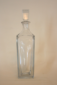 A plain glass square-based decanter with a stopper.