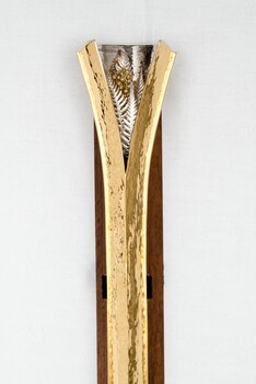 The end of a decorative mace featuring gilded silver ferns and wattle.