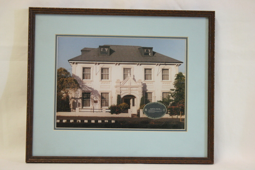 A photograph of Morton House set with a wide blue mount and a simple frame.
