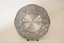 The front of the tray with an inscription in the centre and engravings around the rim.