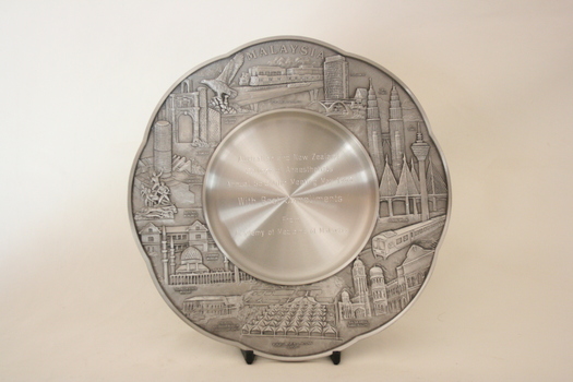The front of the tray with an inscription in the centre and engravings around the rim.