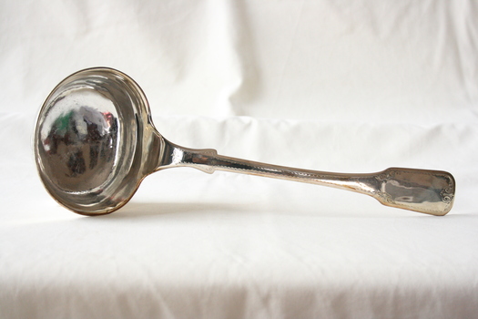 A sterling silver soup ladle.