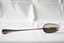 A sterling silver George II basting, stuffing, and hash spoon.
