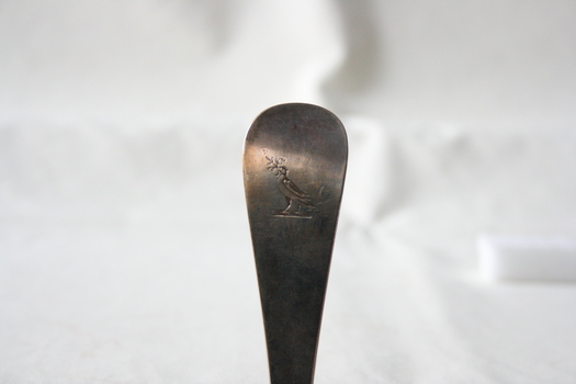 A stamp of a bird on the reverse of the spoon.