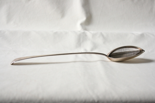 A sterling silver gravy spoon.