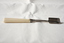 A sterling silver and ivory cheese scoop.