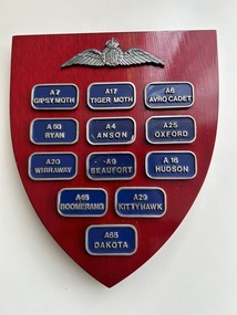 Plaque (Item) - RAAF Wooden Plaque,Fixed With Metal Badges Labelled , A7 Gipsy Moth,A17 Tiger Moth, A6 Avro Cadet, A50 Ryan , A4 Anson, A254 Oxford , A20 Wirraway , A9 Beaufort ,A16 Hudson , A46 Boomeang , A29 Kittyhawk, A65 Dakota