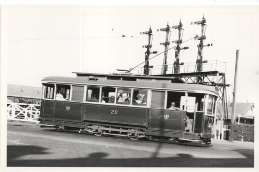 Black & White Tram 20 at Railway level crossing.