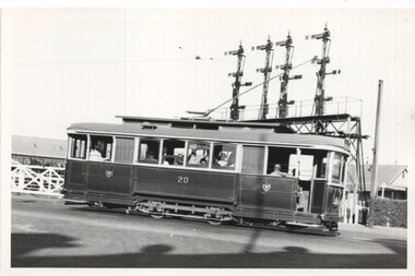 Black & White Tram 20 at Railway level crossing.